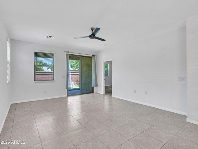 14160 W Georgia Dr, Surprise, AZ 85379 - empty room with a ceiling fan, light tile patterned floors, and baseboards