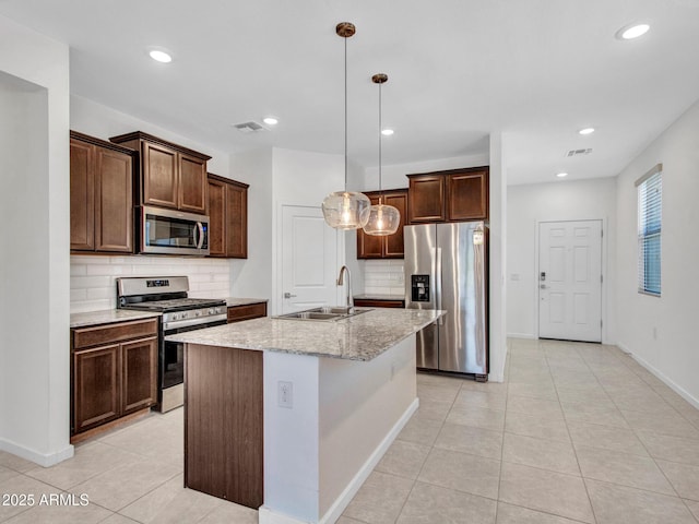 14160 W Georgia Dr, Surprise, AZ 85379 - kitchen featuring appliances with stainless steel finishes, a sink, decorative backsplash, dark brown cabinetry, and light tile patterned flooring