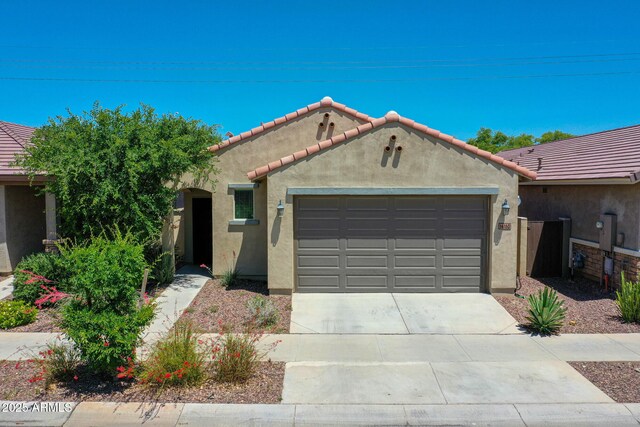 14160 W Georgia Dr, Surprise, AZ 85379 - mediterranean / spanish-style house with stucco siding, a garage, concrete driveway, and a tile roof