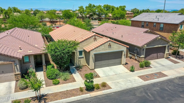 14160 W Georgia Dr, Surprise, AZ 85379 - view of front of home featuring a tile roof, an attached garage, stucco siding, concrete driveway, and a residential view