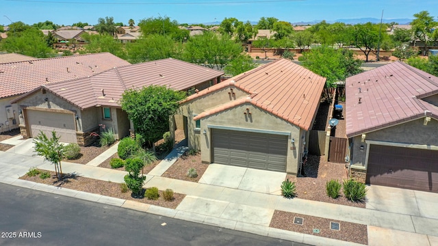 14160 W Georgia Dr, Surprise, AZ 85379 - view of front of home featuring stucco siding, concrete driveway, a tiled roof, and a residential view