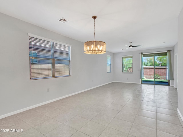 14160 W Georgia Dr, Surprise, AZ 85379 - unfurnished room with a chandelier, baseboards, ceiling fan, and light tile patterned floors