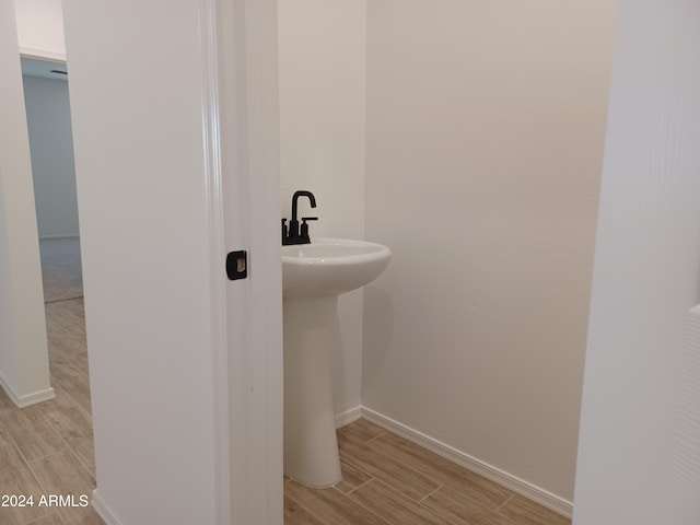 bathroom featuring hardwood / wood-style flooring and sink