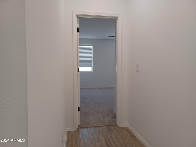 corridor with light hardwood / wood-style flooring