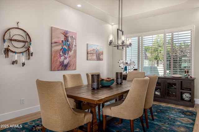 dining area with a chandelier, recessed lighting, baseboards, and wood finished floors