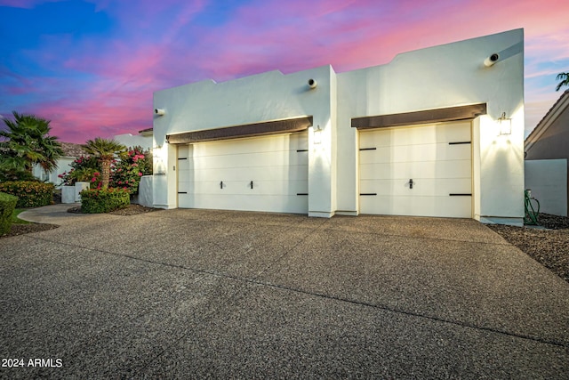 garage featuring concrete driveway