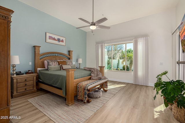 bedroom featuring light wood-style flooring, baseboards, and ceiling fan