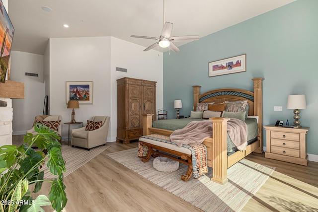 bedroom featuring wood finished floors, visible vents, and a ceiling fan