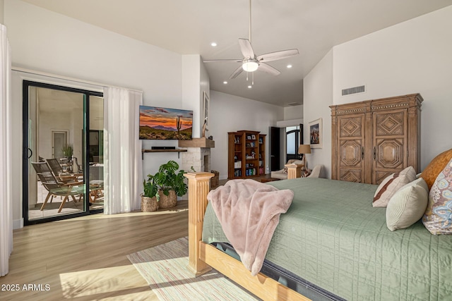 bedroom featuring recessed lighting, visible vents, wood finished floors, high vaulted ceiling, and access to outside