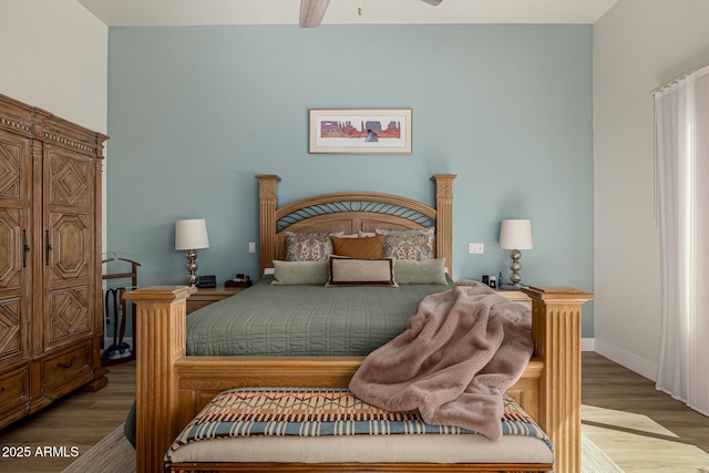 bedroom with a ceiling fan, light wood-type flooring, and baseboards