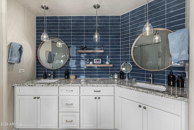 full bathroom featuring double vanity, decorative backsplash, and a sink