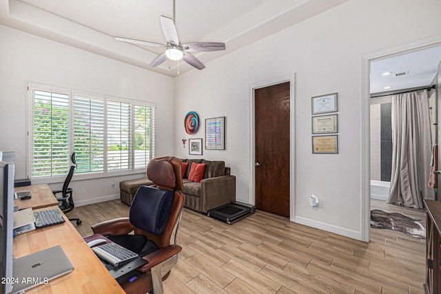 home office featuring ceiling fan, light wood-type flooring, and baseboards