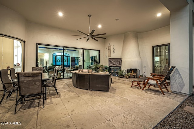 living room featuring recessed lighting, ceiling fan, and a towering ceiling