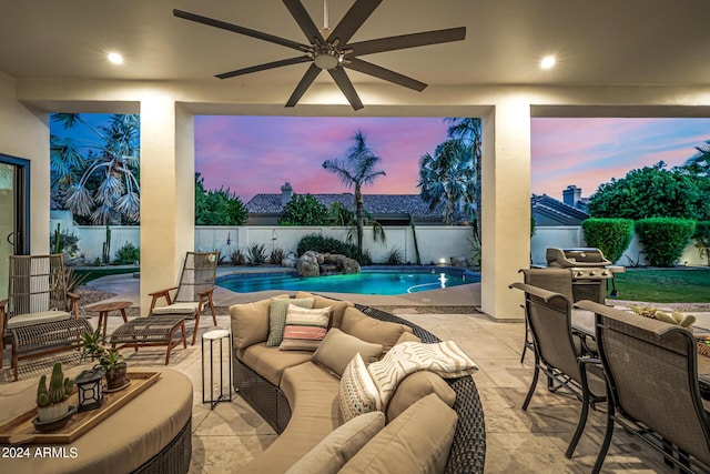 pool at dusk featuring a fenced backyard, outdoor lounge area, a fenced in pool, and a patio