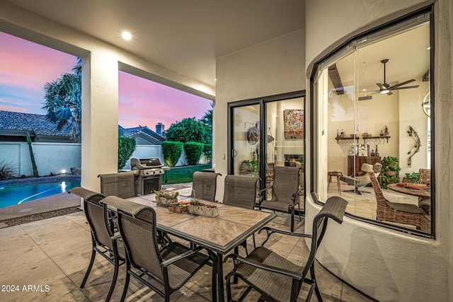 view of patio / terrace with outdoor dining area, area for grilling, and an outdoor pool