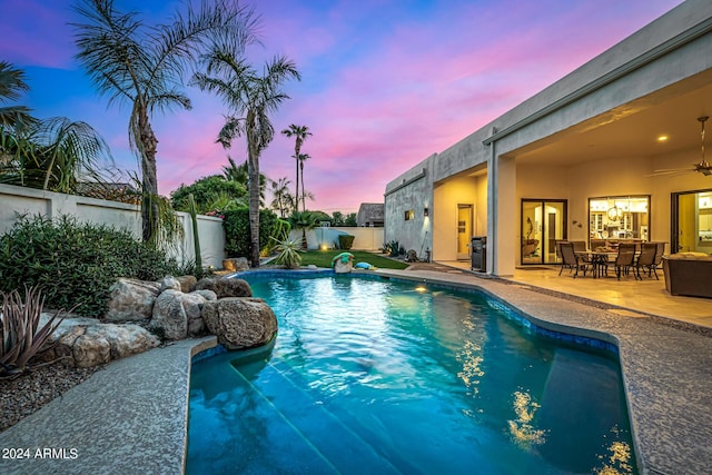 view of pool featuring a patio area, a fenced backyard, ceiling fan, and a fenced in pool