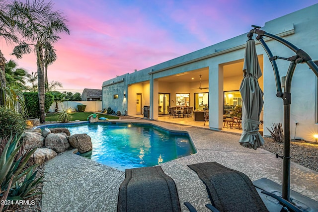 view of swimming pool featuring a fenced in pool, a patio, ceiling fan, fence, and outdoor dining space