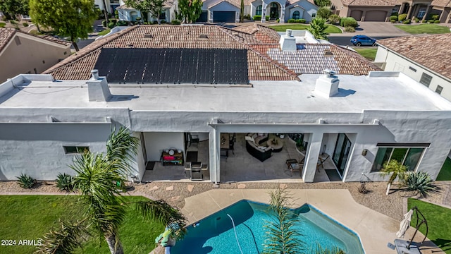 rear view of property featuring a residential view and a patio area