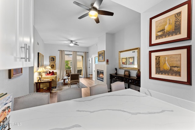 7887 N 16th St Unit 226, Phoenix, AZ 85020 - bedroom featuring wood finished floors, access to exterior, a glass covered fireplace, and ceiling fan