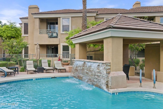 7887 N 16th St Unit 226, Phoenix, AZ 85020 - back of house featuring a chimney, stucco siding, fence, and a patio area