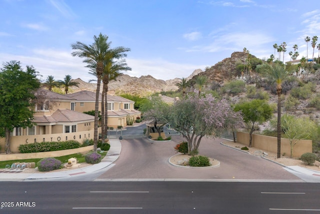 7887 N 16th St Unit 226, Phoenix, AZ 85020 - view of asphalt road with curbs, a mountain view, sidewalks, and a gate