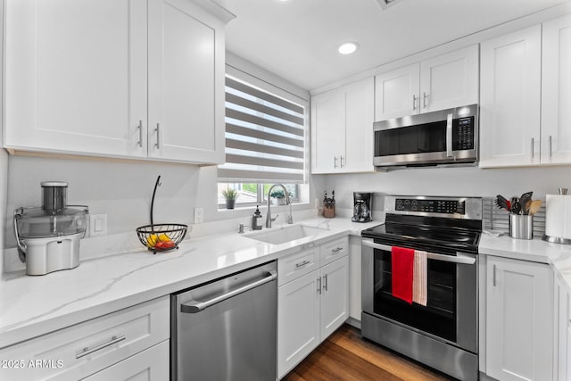 7887 N 16th St Unit 226, Phoenix, AZ 85020 - kitchen featuring appliances with stainless steel finishes, a sink, white cabinetry, recessed lighting, and light stone counters