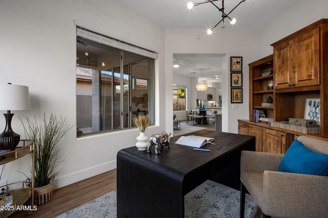 office featuring wood-type flooring and a chandelier