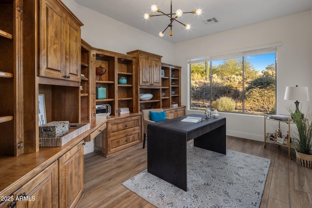 office space with hardwood / wood-style flooring and an inviting chandelier