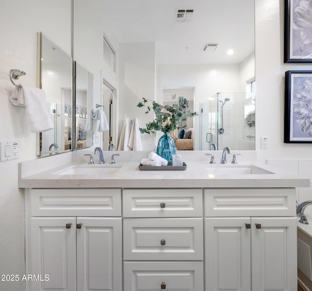 bathroom with vanity and a shower with shower door