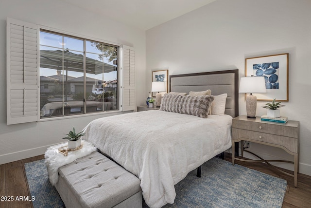 bedroom with dark hardwood / wood-style flooring