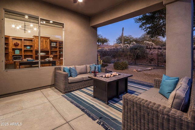 patio terrace at dusk featuring an outdoor living space with a fire pit