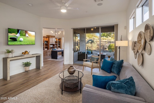 living room with hardwood / wood-style flooring and ceiling fan