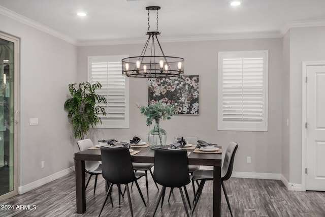 dining area featuring crown molding, a notable chandelier, and hardwood / wood-style flooring