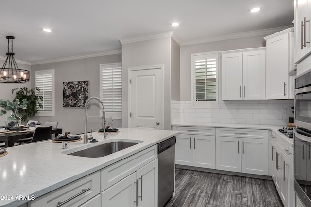 kitchen featuring white cabinets, appliances with stainless steel finishes, hanging light fixtures, and sink