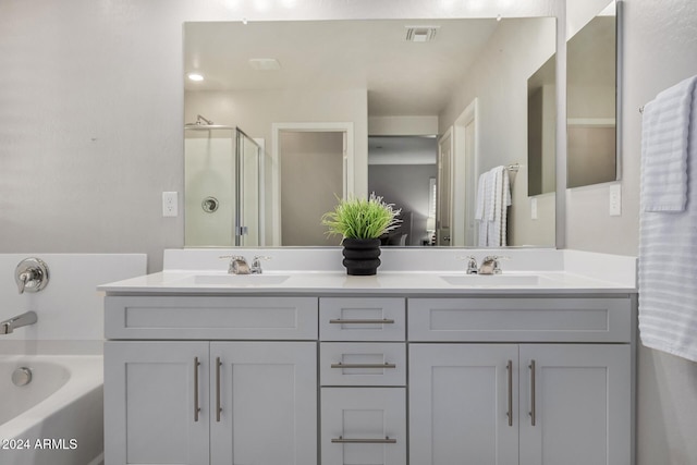 bathroom with vanity and separate shower and tub