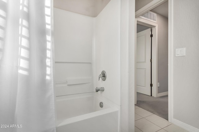 bathroom with tile patterned floors and shower / tub combo with curtain