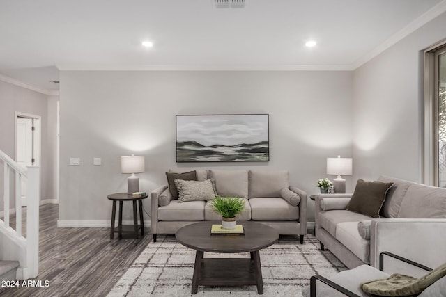 living room featuring hardwood / wood-style flooring and crown molding