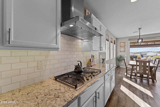 kitchen with wall chimney range hood, white cabinets, dark hardwood / wood-style floors, and stainless steel gas stovetop