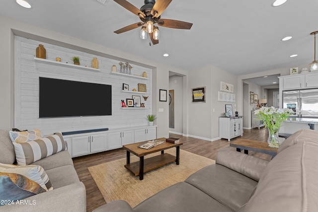 living room with ceiling fan and dark hardwood / wood-style floors