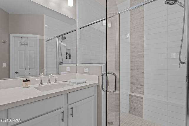 bathroom featuring an enclosed shower and vanity