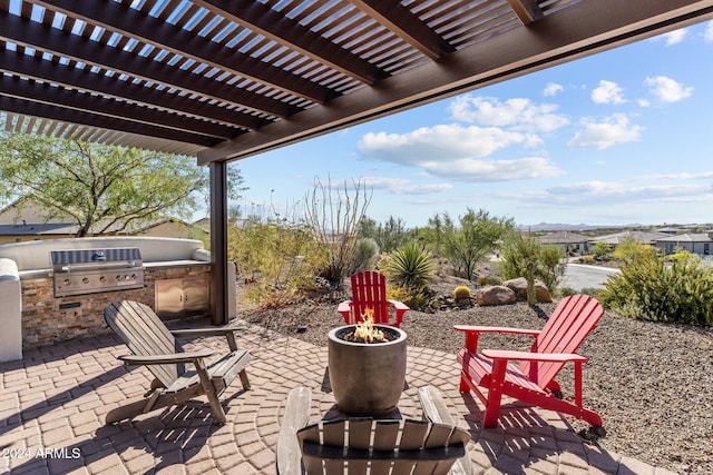 view of patio with grilling area, a pergola, and exterior kitchen