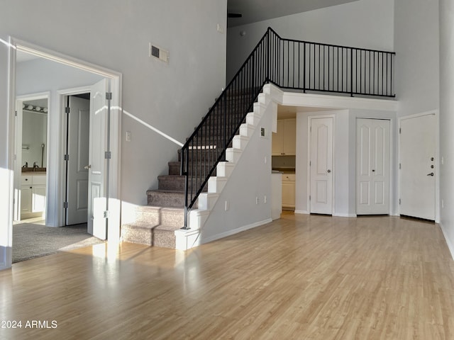 interior space with a high ceiling and light wood-type flooring