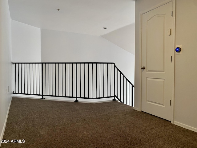 staircase featuring vaulted ceiling and carpet flooring