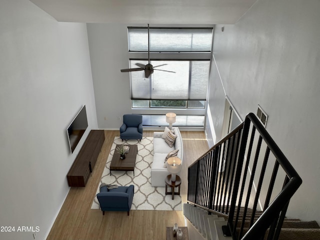 unfurnished living room featuring hardwood / wood-style flooring and ceiling fan