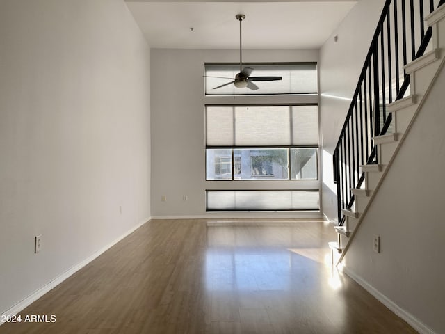 unfurnished living room with hardwood / wood-style flooring and ceiling fan