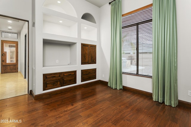 4401 E Taurus Pl, Chandler, AZ 85249 - unfurnished living room featuring baseboards and hardwood / wood-style floors