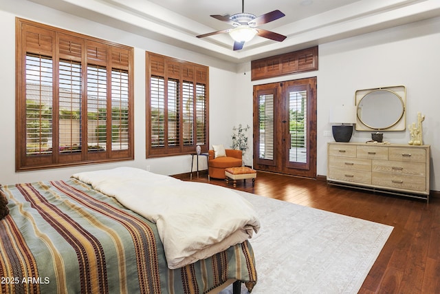 4401 E Taurus Pl, Chandler, AZ 85249 - bedroom with dark wood-style floors, ceiling fan, a raised ceiling, and access to outside