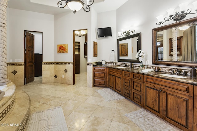 4401 E Taurus Pl, Chandler, AZ 85249 - full bath with a bath, double vanity, a sink, and an inviting chandelier