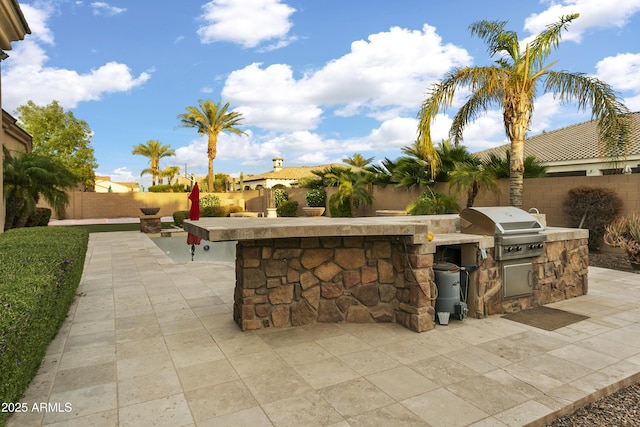 4401 E Taurus Pl, Chandler, AZ 85249 - view of patio / terrace featuring a fenced backyard, an outdoor kitchen, and area for grilling