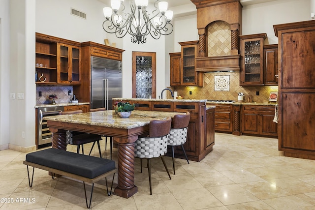 4401 E Taurus Pl, Chandler, AZ 85249 - kitchen with visible vents, stainless steel appliances, a center island with sink, beverage cooler, and a notable chandelier